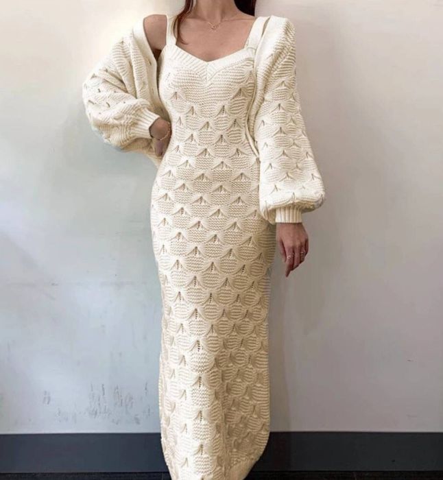 A model showcases the dress and sweater set in a fresh white hue.