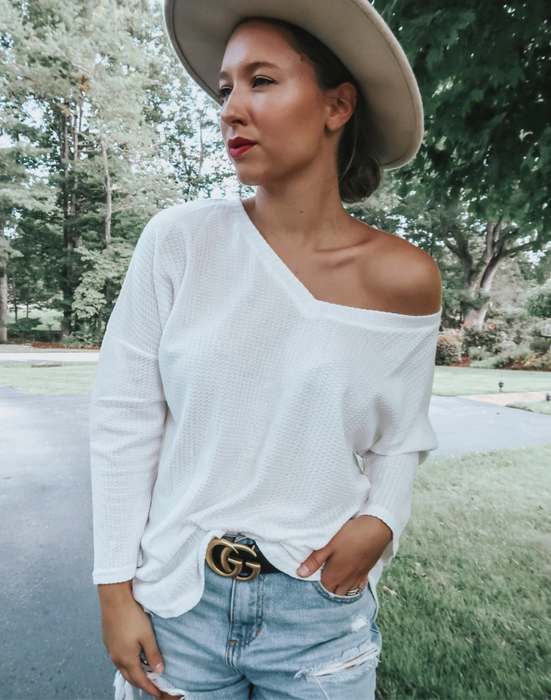 A customer review photo showcasing the white thermal top.