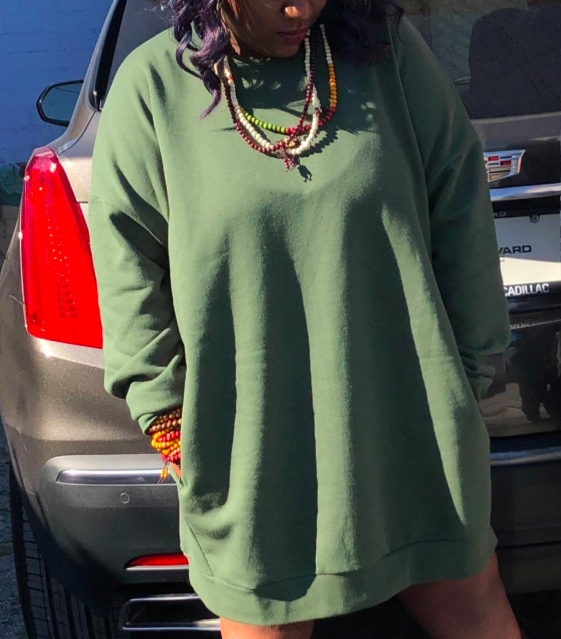 A customer review photo showing them wearing the tunic in green.