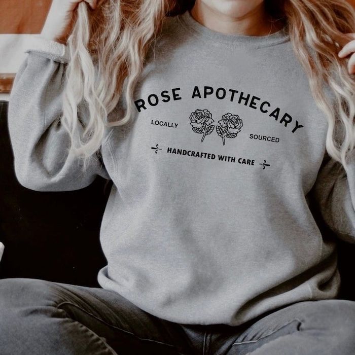 A model showcasing the sweatshirt in a soft light gray shade.