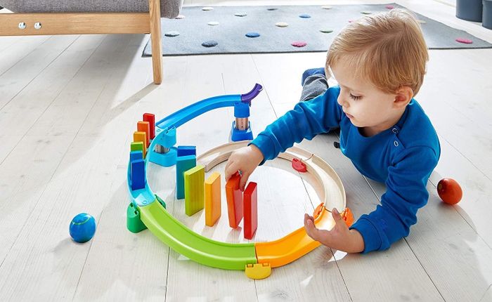 A child playing with a colorful domino playset