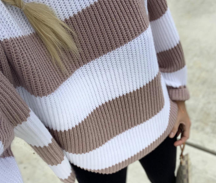 A close-up photo from a customer showing them wearing the sweater