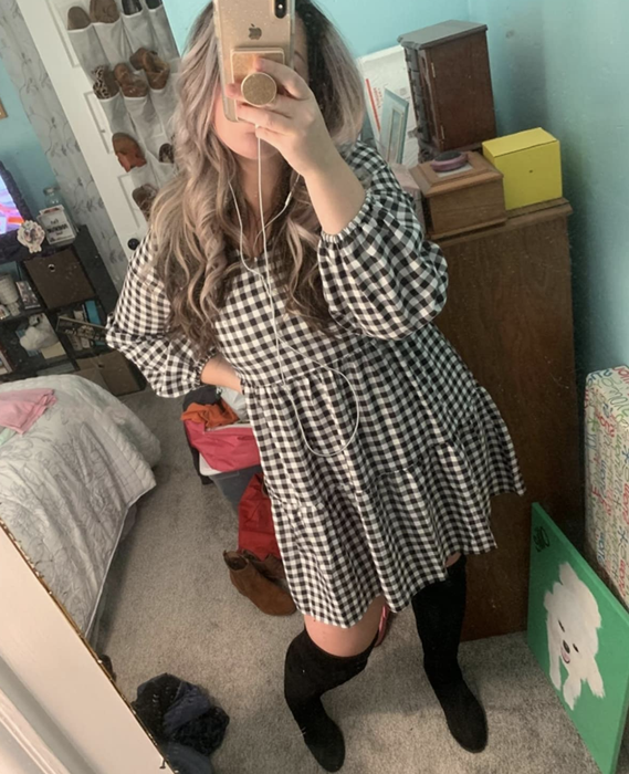 A customer posted a mirror selfie wearing the dress.