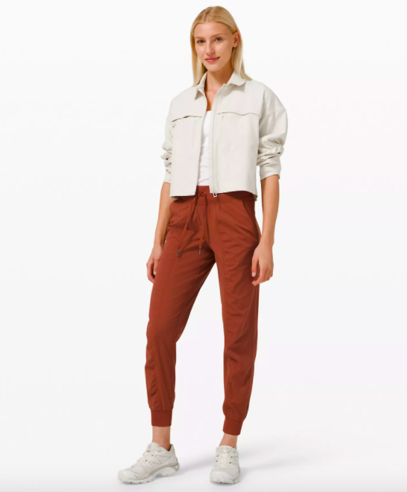 A model showcasing the joggers in Dark Terracotta.