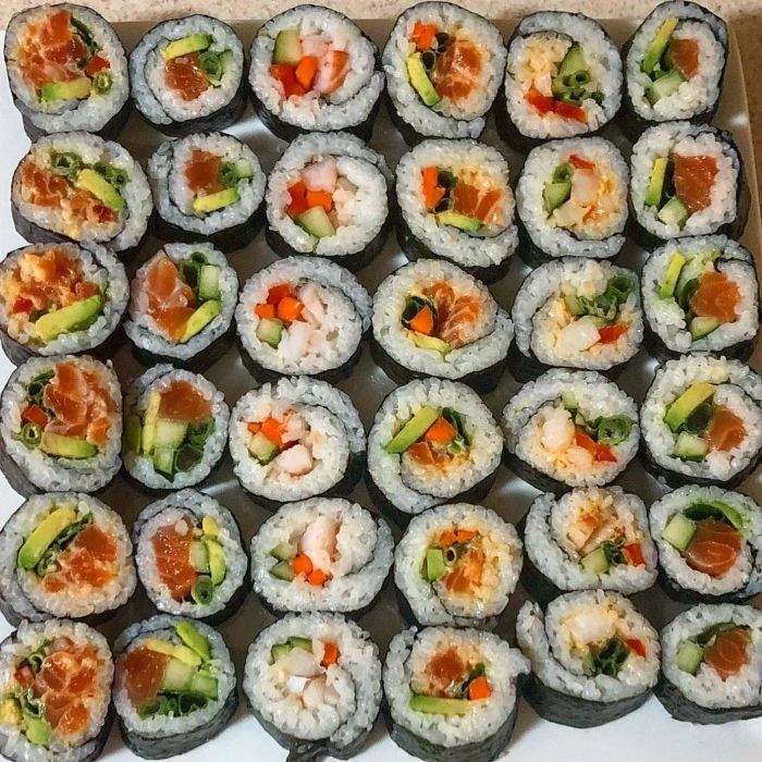A vibrant plate of sushi rolls with fish, avocado, and seaweed, made by the reviewer