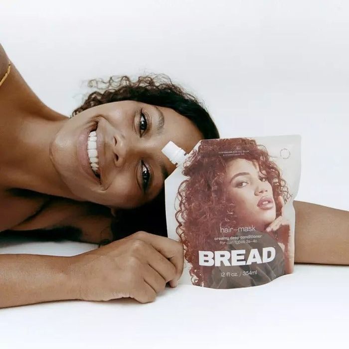 model posing next to the hair mask