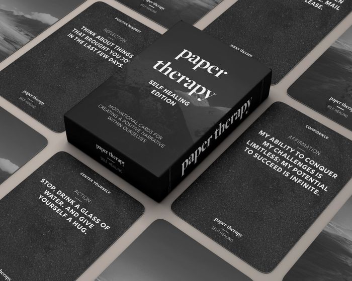 The cards laid out flat next to their matching box.