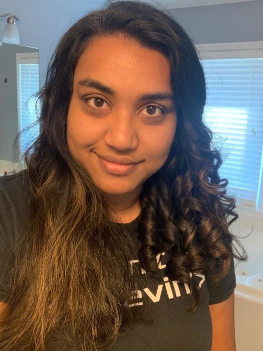 The reviewer showcases the difference in their hair's appearance before and after using a curling iron.