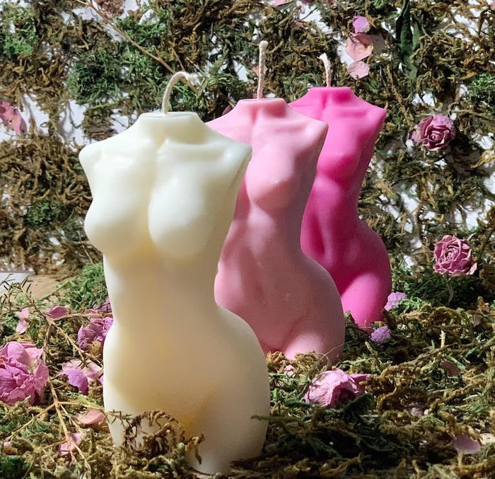 Three candles in shades of cream, light pink, and hot pink, all identical in design.