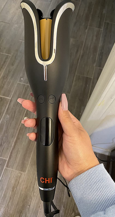 A reviewer demonstrating how they use their Chi curling tool.