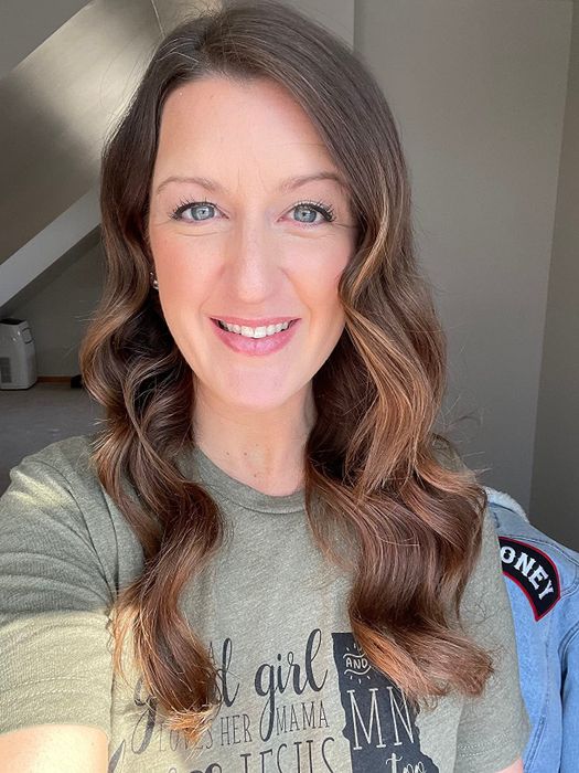 A reviewer proudly showing off her curly hair.