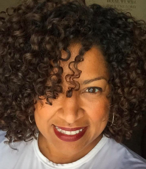 A reviewer showcasing their curls after using the diffuser