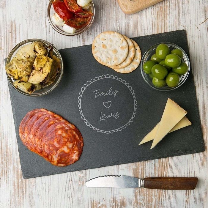 A black slate cheeseboard with the phrase