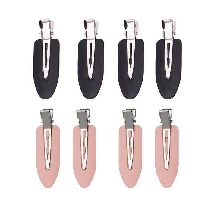 A set of eight hair clips, four in black and four in pink, arranged in rows for easy selection of fashion accessories
