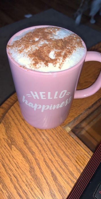 A reviewer's frothy drink served in a cozy mug