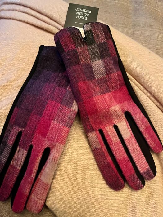 A reviewer showcasing the gloves in pink, red, and purple.