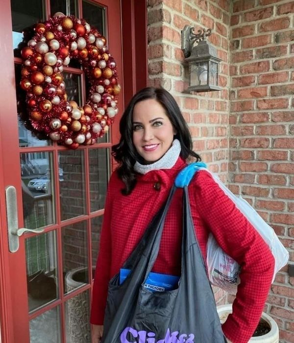 The handles of bags resting comfortably on someone's shoulder.
