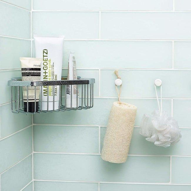 Bathroom tile surround with a caddy mounted on the wall using the moldable glue.