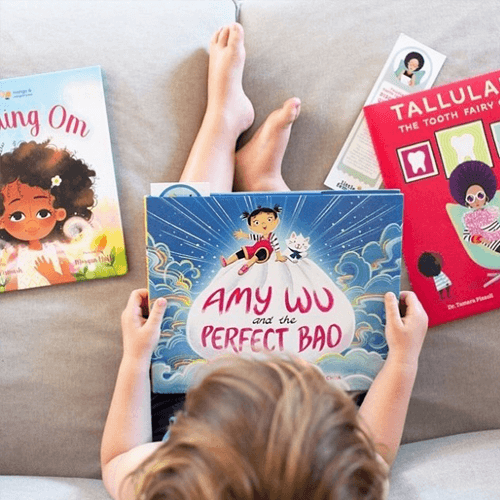 A bird's-eye view of a child holding the book 'Amy Wu and the Perfect Bao'.