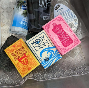 Book-shaped sponges with clever, dish-related titles, perfect for adding some fun to the kitchen routine.
