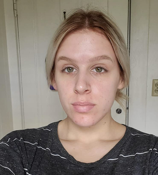 A reviewer before applying the BB cream.