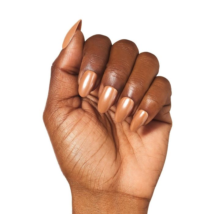 A hand adorned with almond-shaped nails glittering in bronze.
