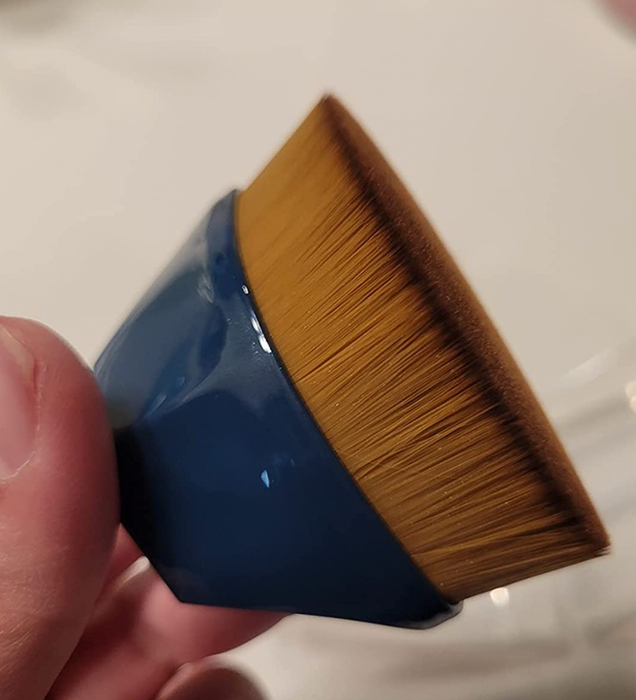 A small round fine-bristled makeup brush