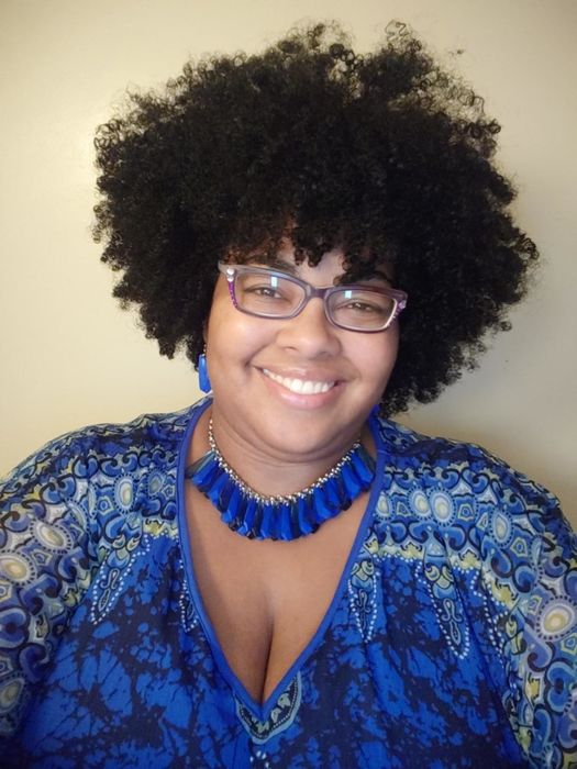 A photo of a reviewer showing off their curly hair