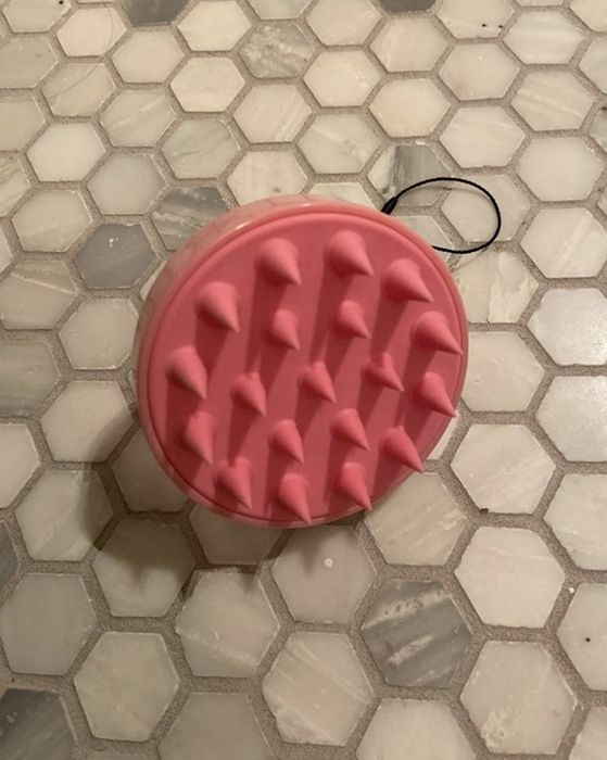 a pink shampoo brush