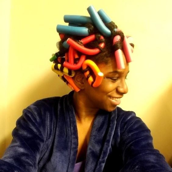 A reviewer styling their hair with foam rods.
