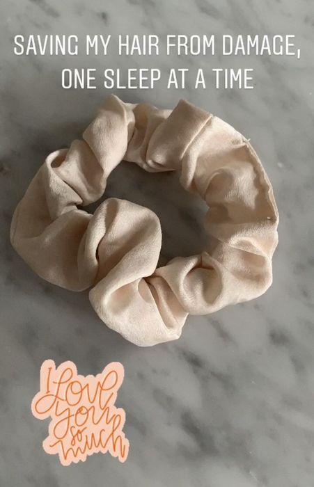 The satin scrunchie, featuring a printed text design.