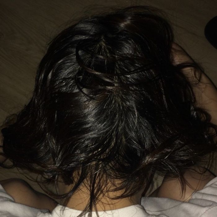 a person with visibly thicker hair after using castor oil