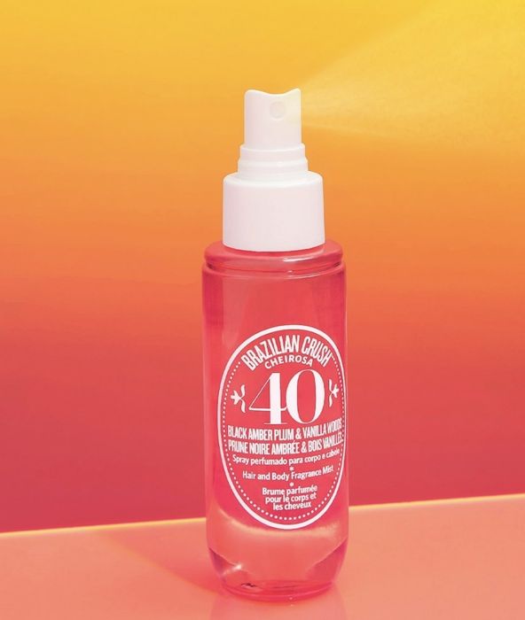 a pink spray bottle featuring a white nozzle