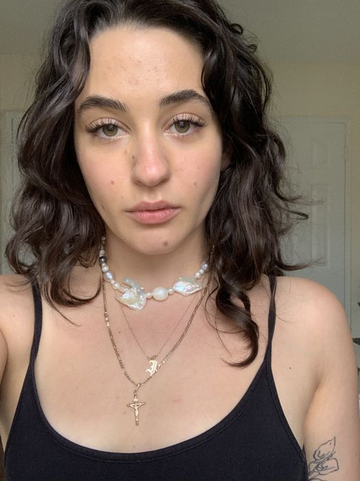 Isabella showcasing beautifully defined curls after applying the conditioner
