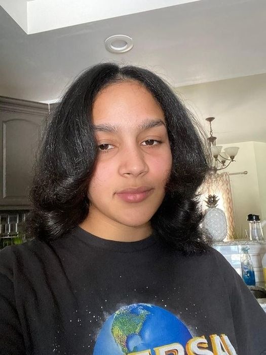 Reviewer's after photo with sleek, blowout-styled hair