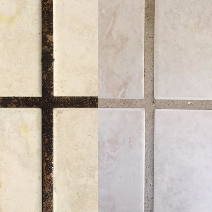 a close-up photo from a reviewer of grimy grout contrasted with freshly cleaned grout