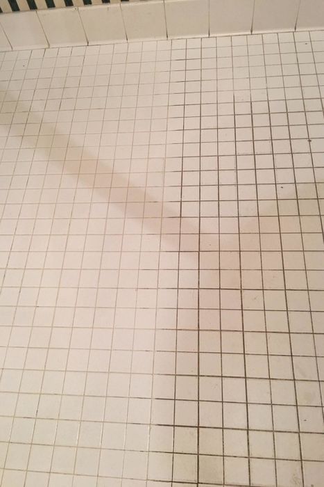 A side-by-side comparison from a reviewer showing dirty tiles on one side and significantly cleaner, whiter tiles on the other