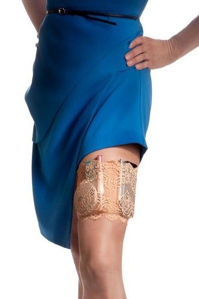 A model showcasing a blue dress paired with a stylish lace garter, holding a phone and a makeup compact securely inside.