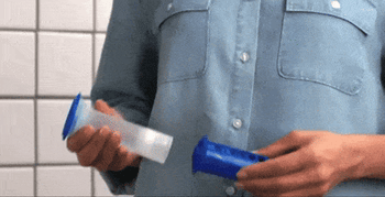 A gif showing someone applying the gel stamp onto a toilet bowl.