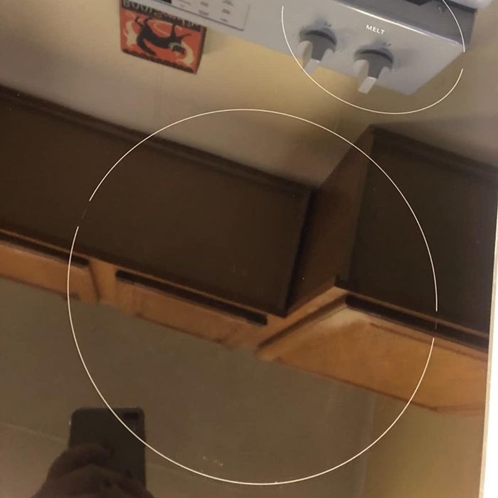 The same reviewer shows their stove top looking brand new and shining brightly after using the cleaning kit.
