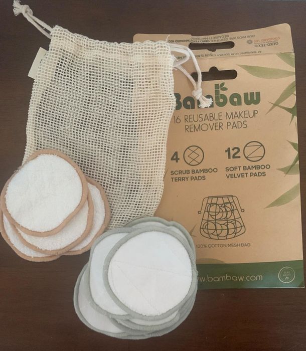 a reviewer’s photo of the two types of cotton rounds and the mesh laundry bag included