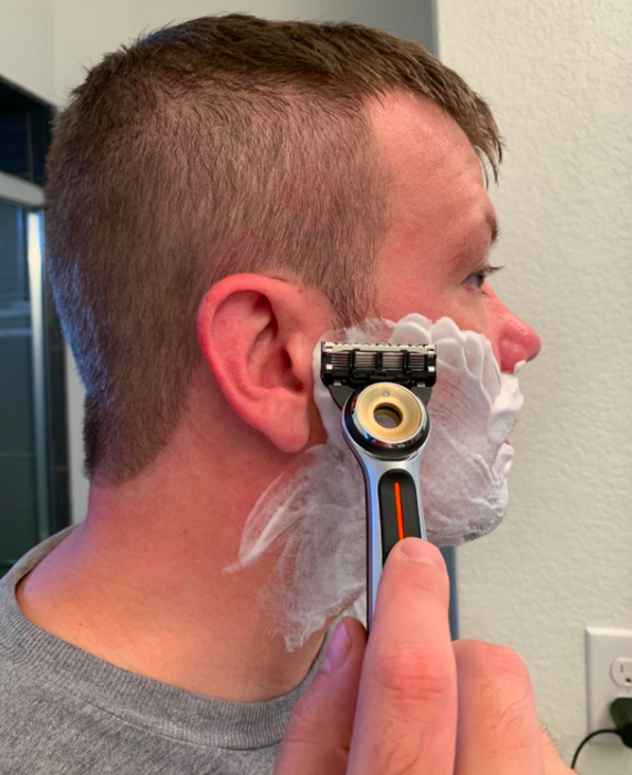 a reviewer using the heated razor to shave