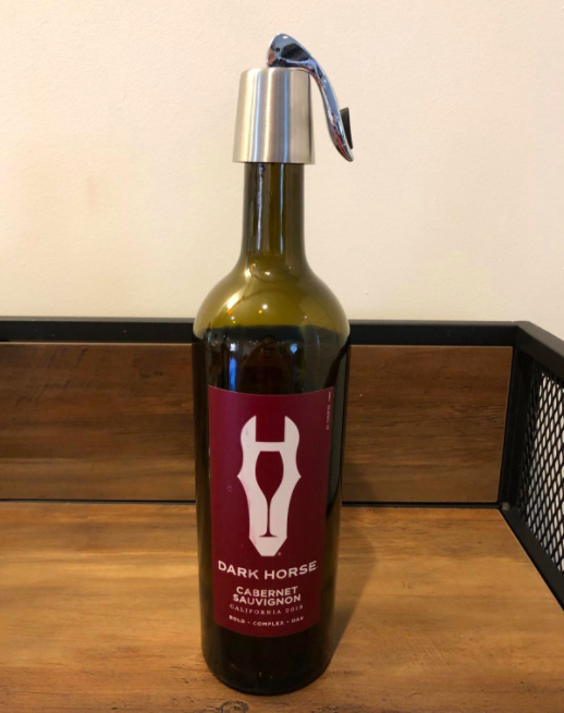 a reviewer’s photo of the wine stopper in action on a bottle of red wine