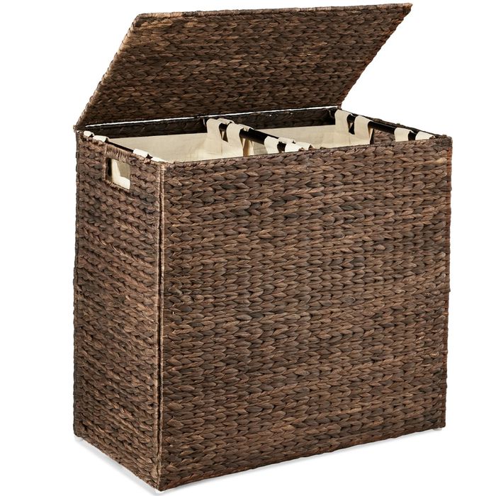 A woven wicker laundry hamper with a hinged lid, removable fabric liners, and side handles for easy transport, perfect for home organization