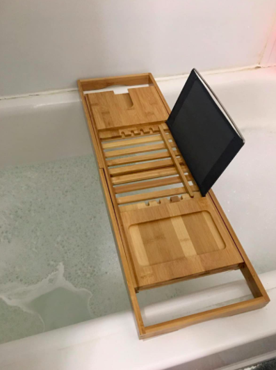 a reviewer’s photo of the bamboo tub caddy supporting an iPad