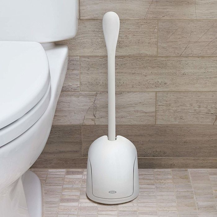 The white long-handled brush stored in its cover.