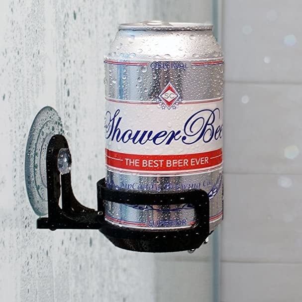 a suction cup caddy in a shower holding a can of beer