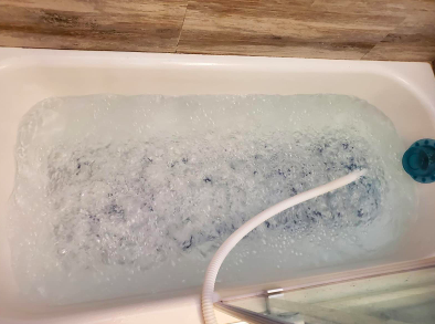 The same reviewer’s tub with the mat activated, showing a frothy mass of bubbles rising from the air pads.