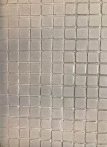 After photo of the same bathroom tiles now gleaming after using the grout pen