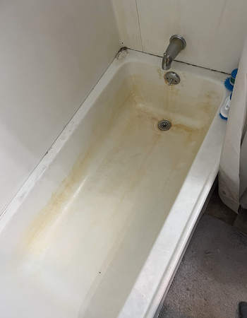 a before photo displaying a reviewer's bathtub in a dirty state